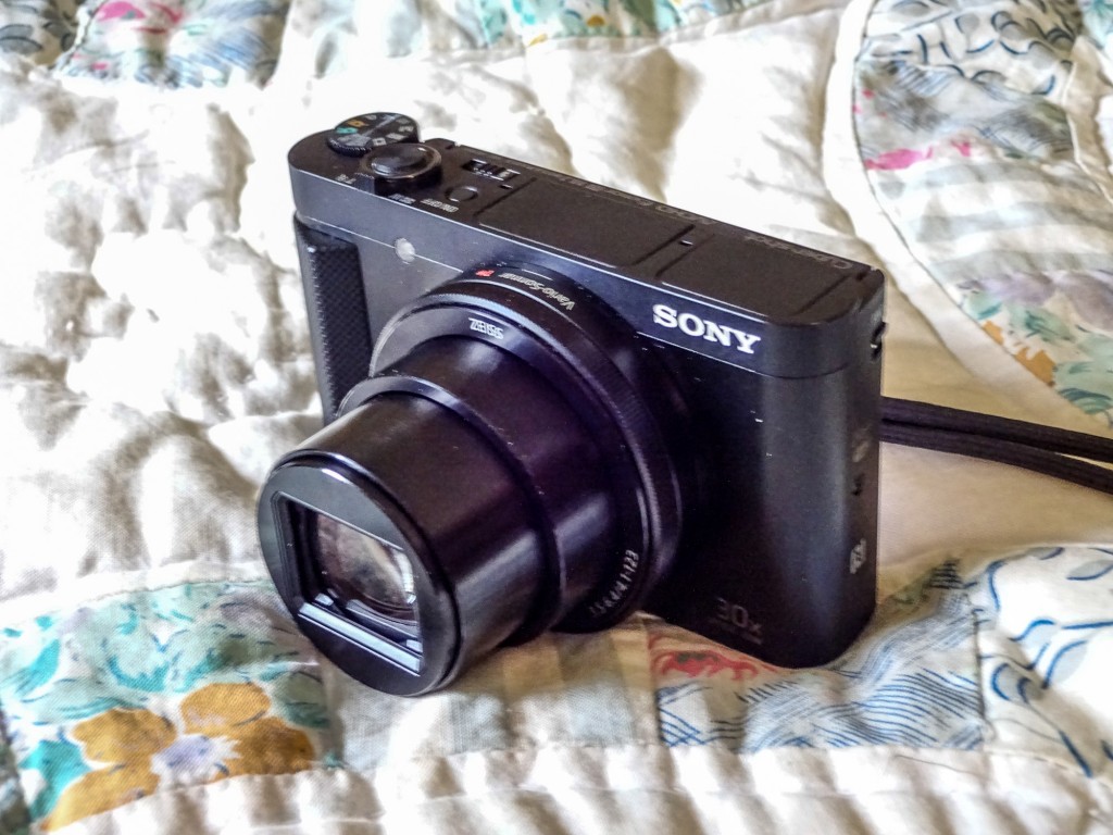 Sony HX90V. Notice finger grip, and control ring around lens next to the body. 